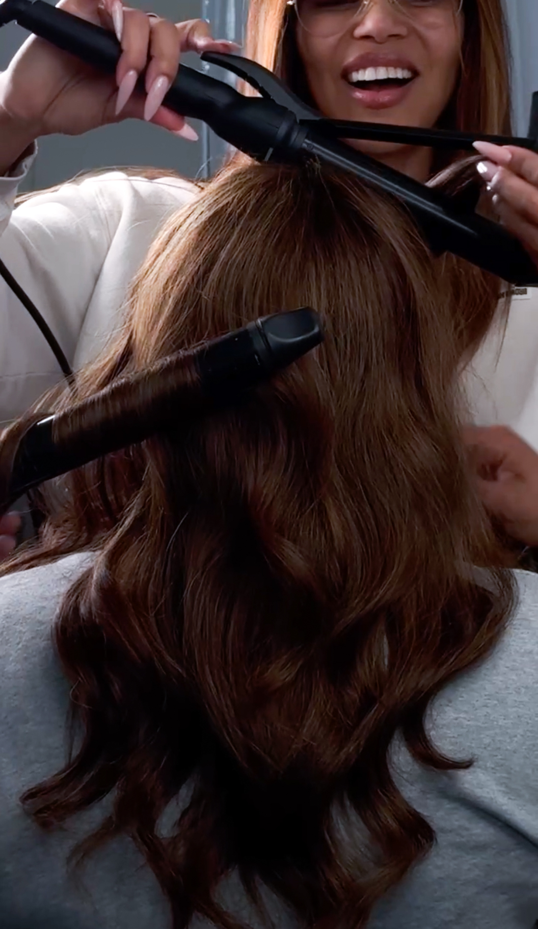 a woman having her hair system curled to inspire confidence in intimacy